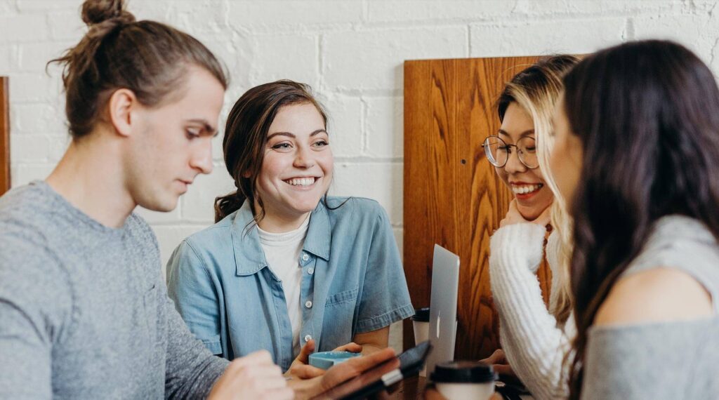 People smiling around a table